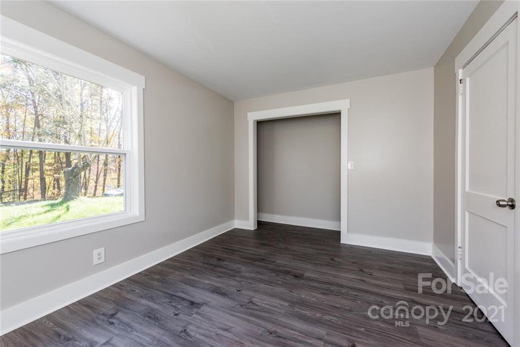 87-j R J R Sayles Road Canton, NC 28716 - Photo 11 of 22 a view of an empty room with wooden floor and a window