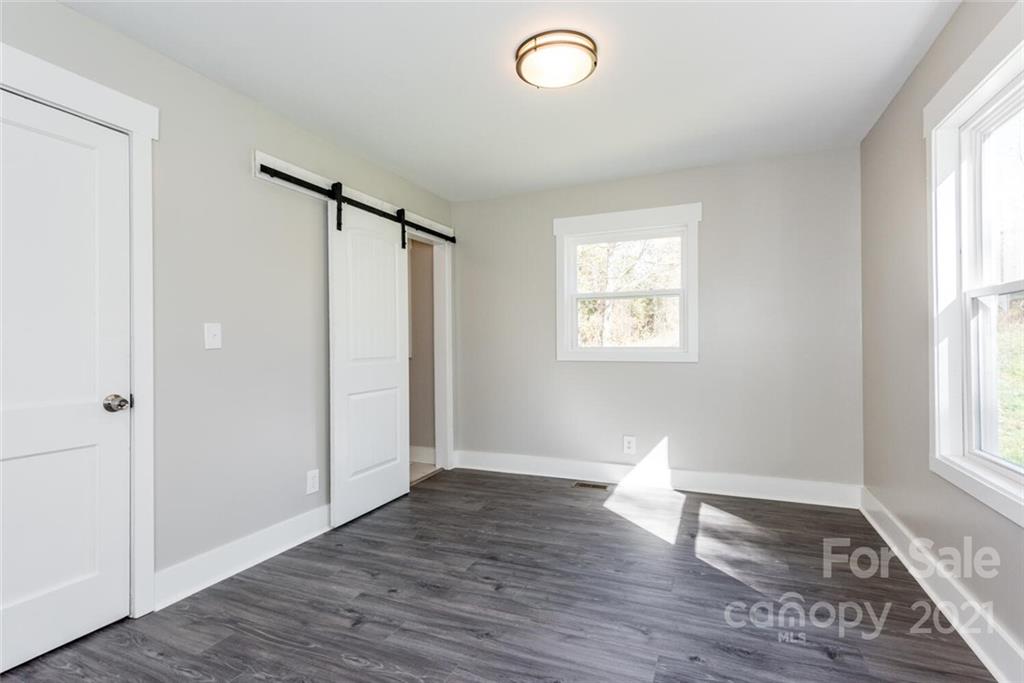 87-j R J R Sayles Road Canton, NC 28716 - Photo 13 of 22 an empty room with wooden floor and windows