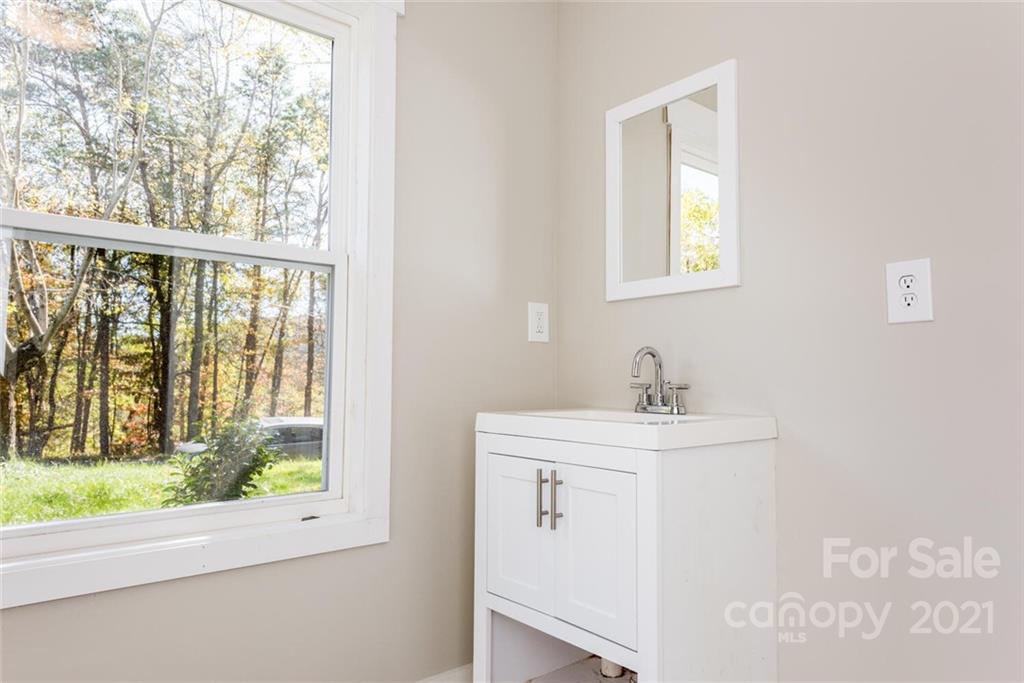 87-j R J R Sayles Road Canton, NC 28716 - Photo 14 of 22 a bathroom with a sink a mirror and a window