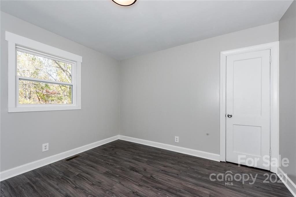 87-j R J R Sayles Road Canton, NC 28716 - Photo 16 of 22 a view of an empty room with wooden floor and a window