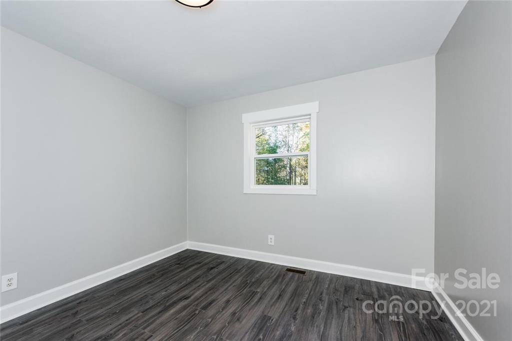 87-j R J R Sayles Road Canton, NC 28716 - Photo 17 of 22 an empty room with wooden floor and windows
