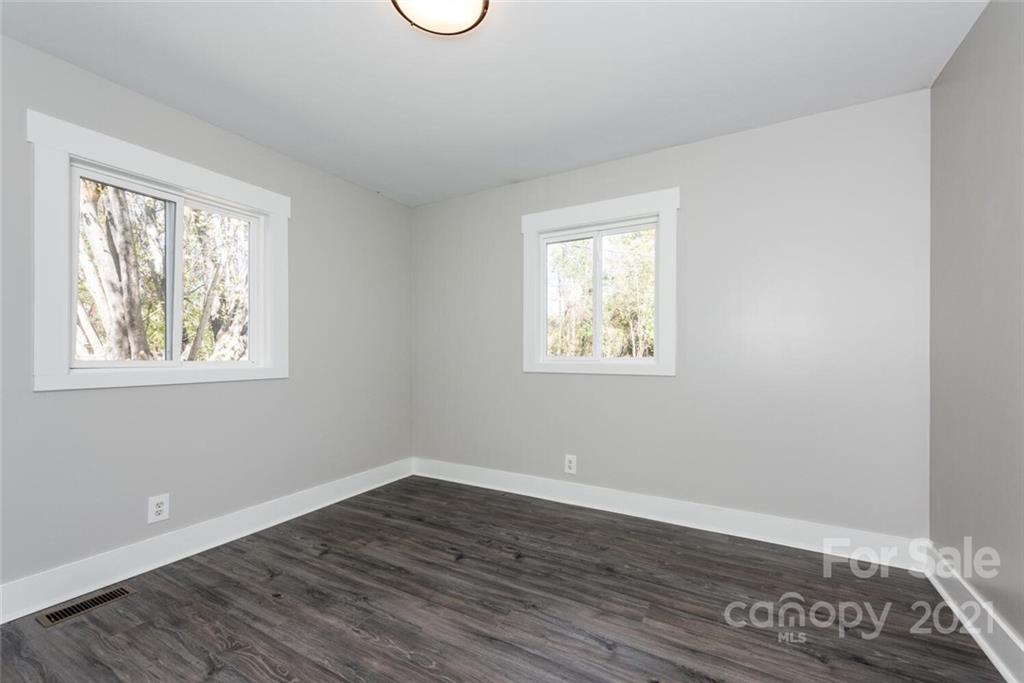 87-j R J R Sayles Road Canton, NC 28716 - Photo 18 of 22 a view of an empty room with wooden floor and a window