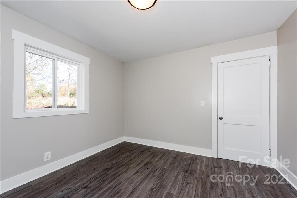 87-j R J R Sayles Road Canton, NC 28716 - Photo 19 of 22 an empty room with wooden floor and windows