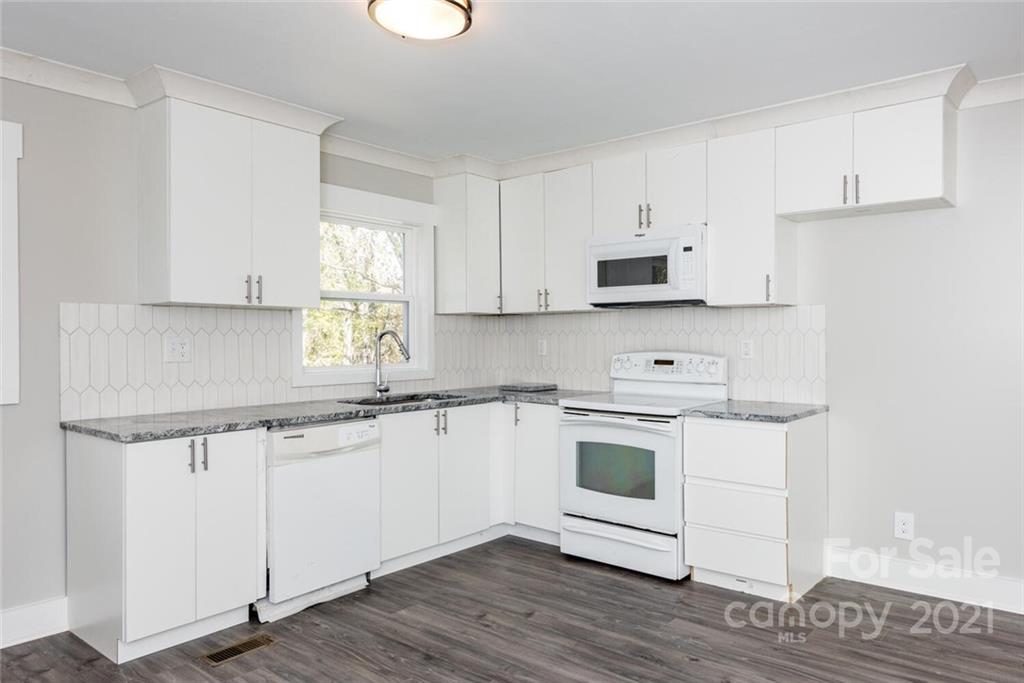 87-j R J R Sayles Road Canton, NC 28716 - Photo 7 of 22 a kitchen with stainless steel appliances granite countertop a stove a sink and white cabinets
