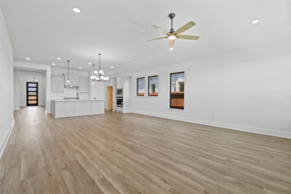 1792 Monarch Way Oak Point, TX 75068 - Photo 14 of 26 an empty room with wooden floor and windows
