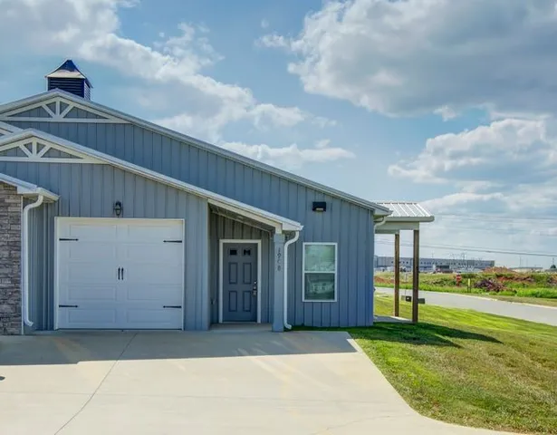 a view of a house with backyard porch and garden