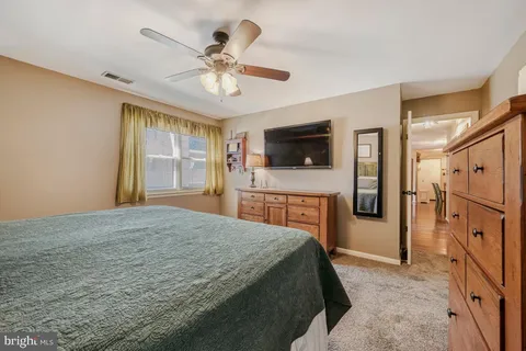 a view of walk in closet with clothes