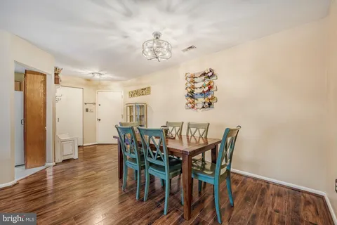 a kitchen with stainless steel appliances granite countertop a stove top oven a sink a refrigerator and cabinets