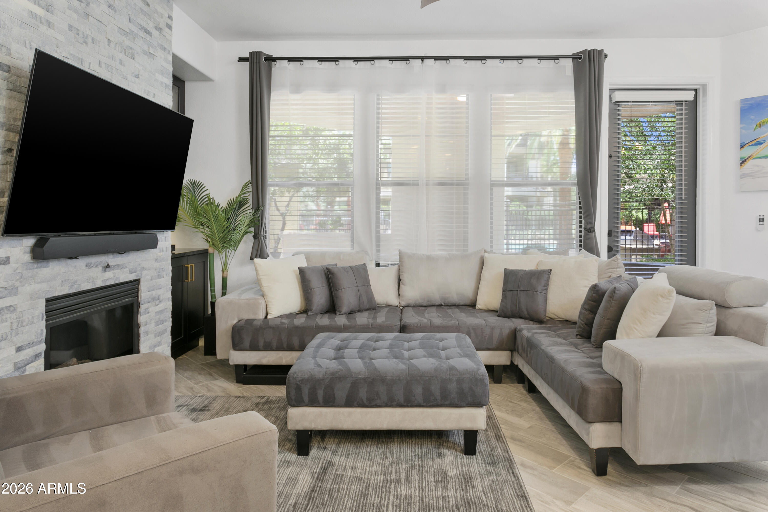 7601 East Indian Bend Road, Unit 1017 Scottsdale, AZ 85250 - Photo 13 of 49 a living room with furniture a fireplace and a flat screen tv