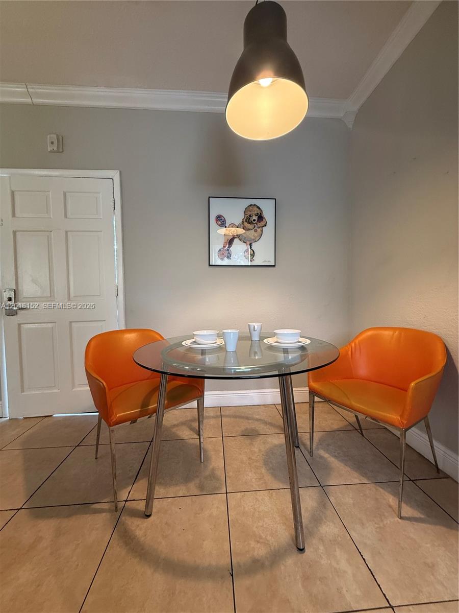 7710 Harding Avenue, Unit 7 Miami Beach, FL 33141 - Photo 8 of 9 a view of a chairs and table in a room