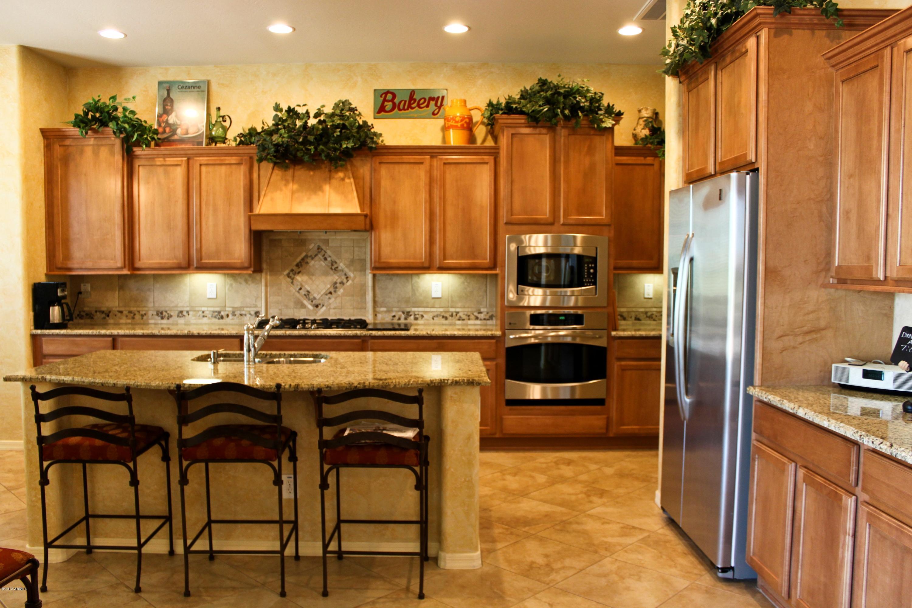1928 West Peak View Road Phoenix, AZ 85085 - Photo 11 of 35 a kitchen with a refrigerator and cabinets