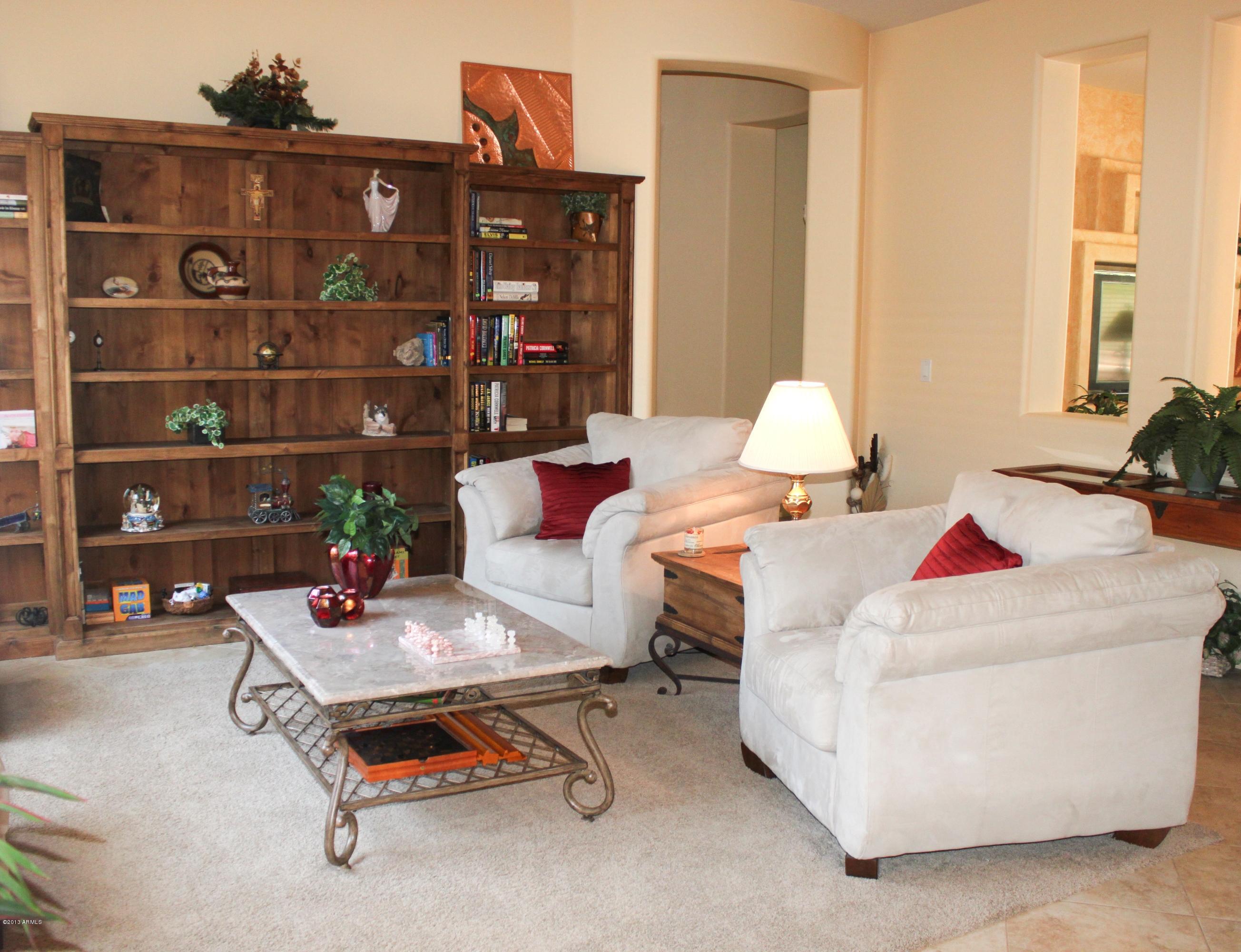 1928 West Peak View Road Phoenix, AZ 85085 - Photo 15 of 35 a living room with furniture a lamp and a window