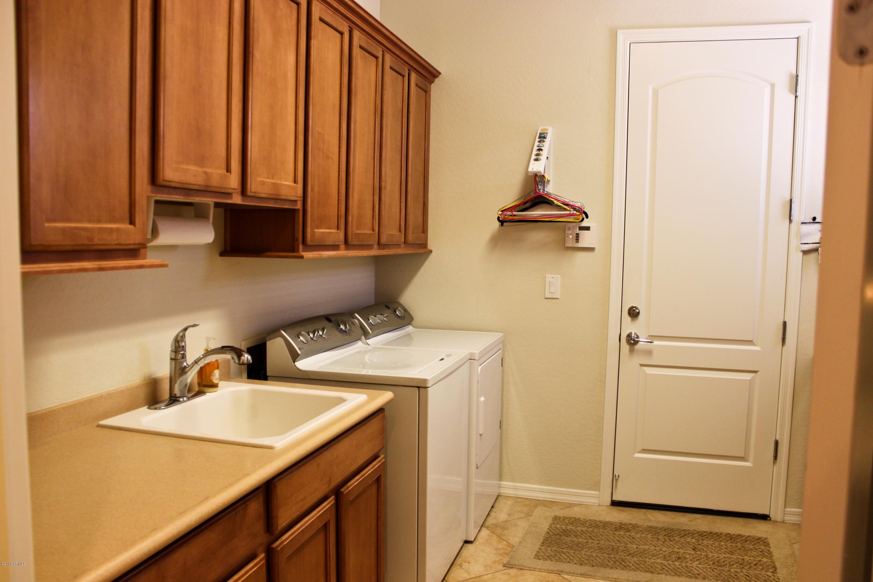 1928 West Peak View Road Phoenix, AZ 85085 - Photo 16 of 35 a kitchen with a sink and a refrigerator