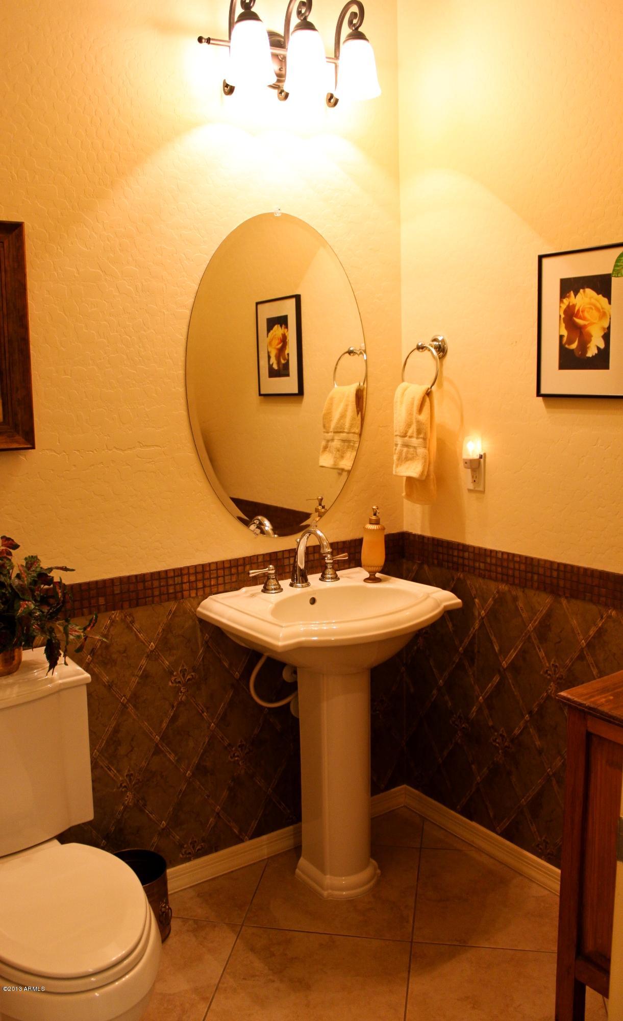 1928 West Peak View Road Phoenix, AZ 85085 - Photo 17 of 35 a bathroom with a sink a mirror and toilet