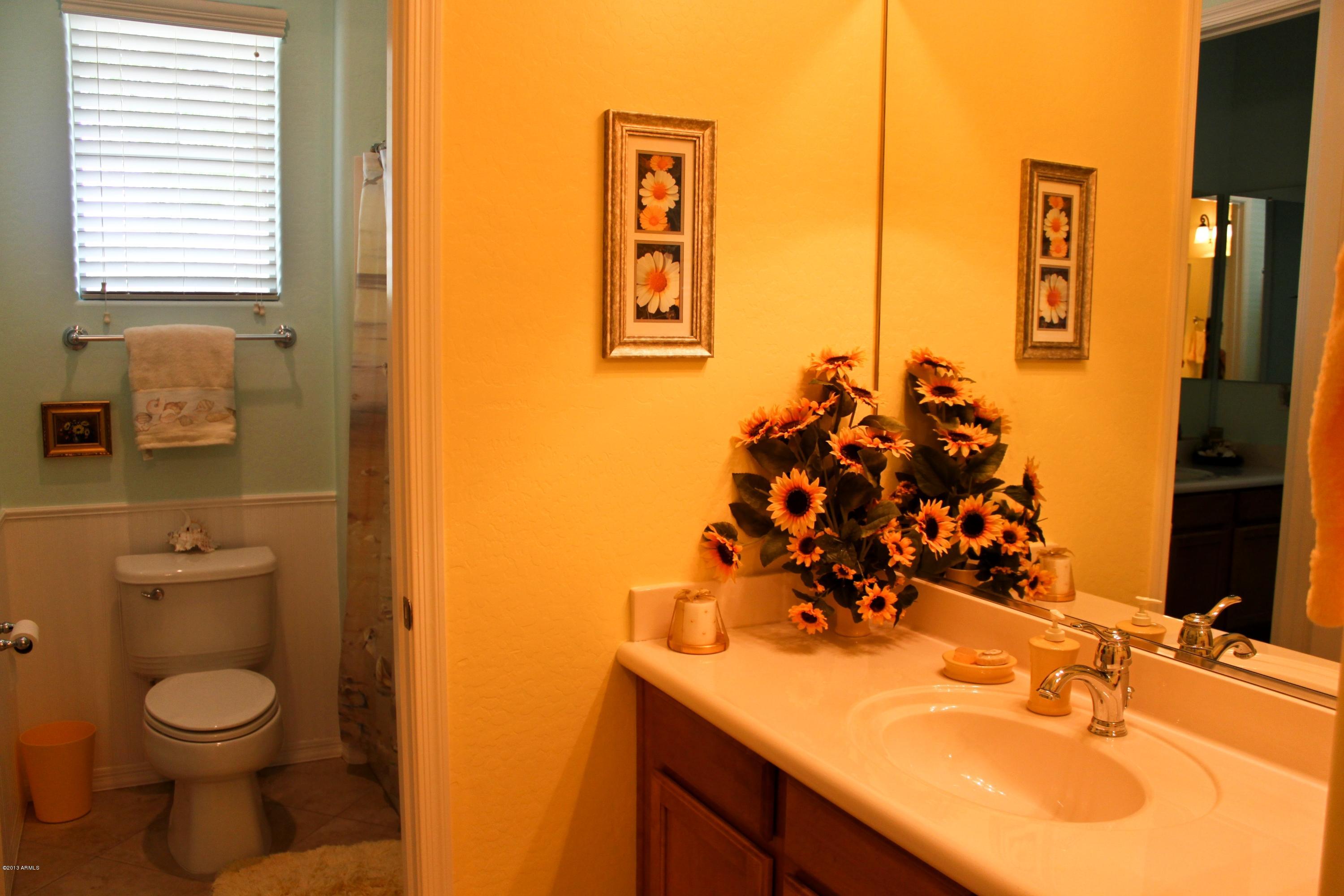 1928 West Peak View Road Phoenix, AZ 85085 - Photo 20 of 35 a bathroom with a toilet sink and mirror