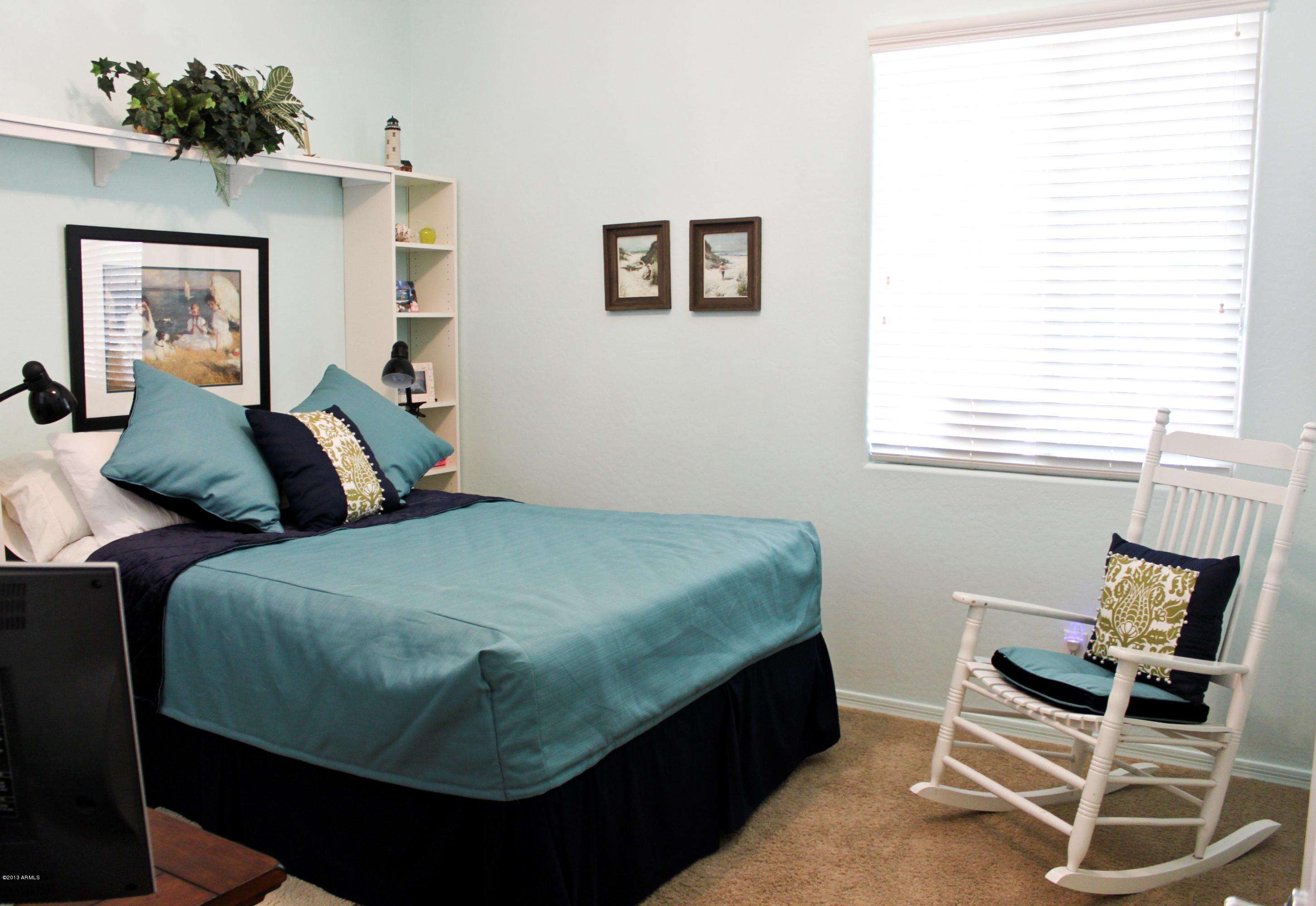 1928 West Peak View Road Phoenix, AZ 85085 - Photo 21 of 35 a bedroom with a bed and chair