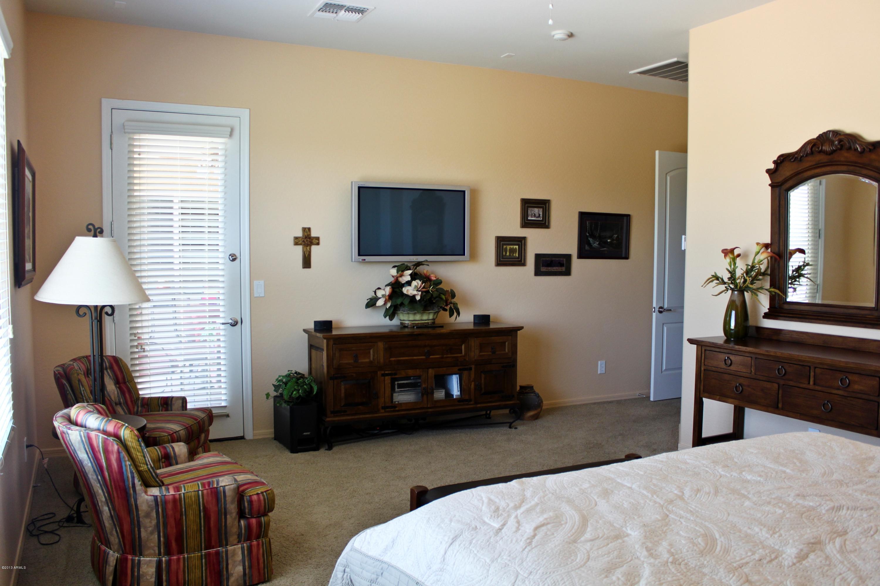 1928 West Peak View Road Phoenix, AZ 85085 - Photo 28 of 35 a bedroom with furniture a bed and a flat screen tv