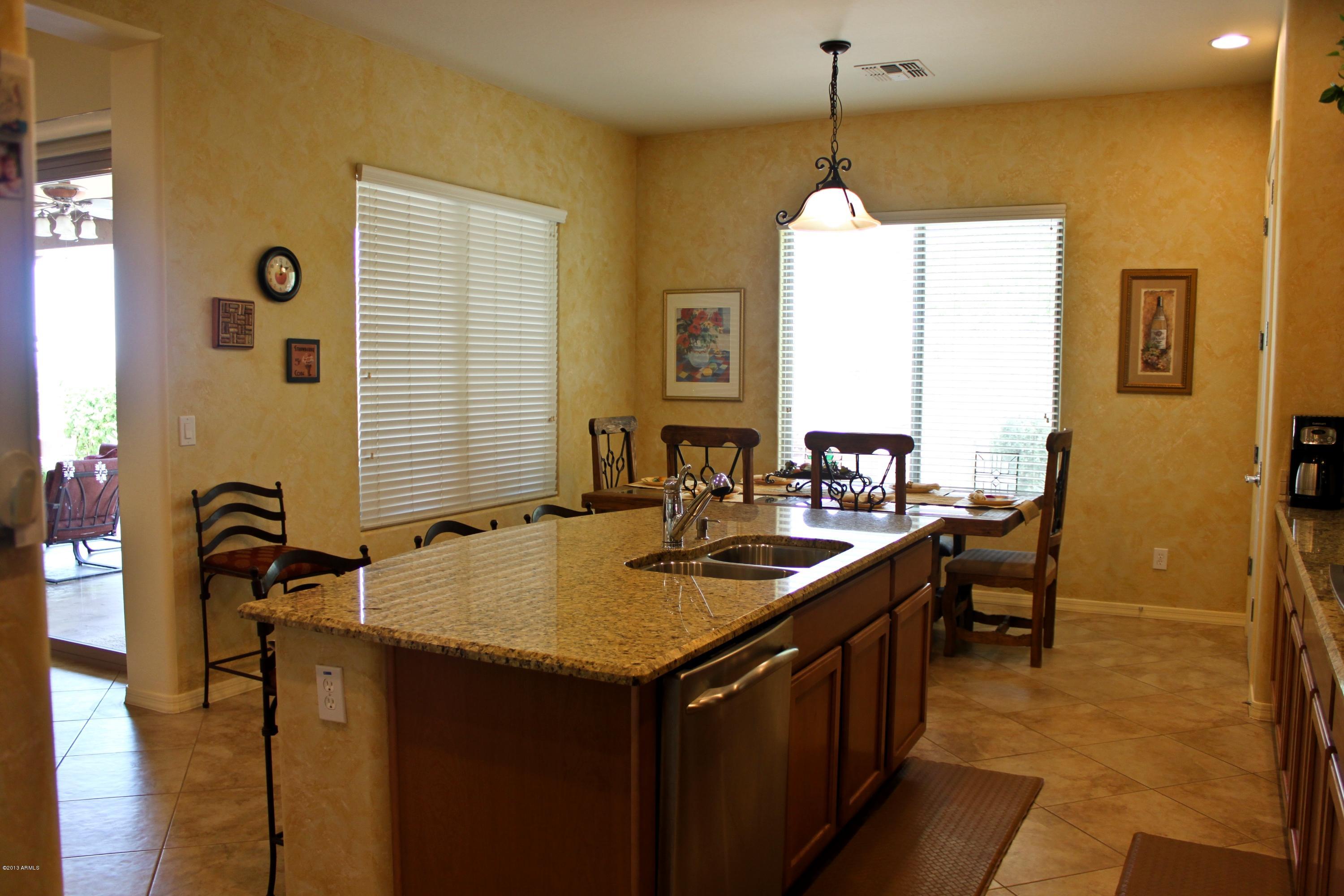 1928 West Peak View Road Phoenix, AZ 85085 - Photo 9 of 35 a kitchen with a sink stove and cabinets