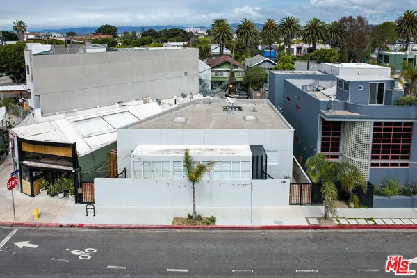 an aerial view of residential houses with yard