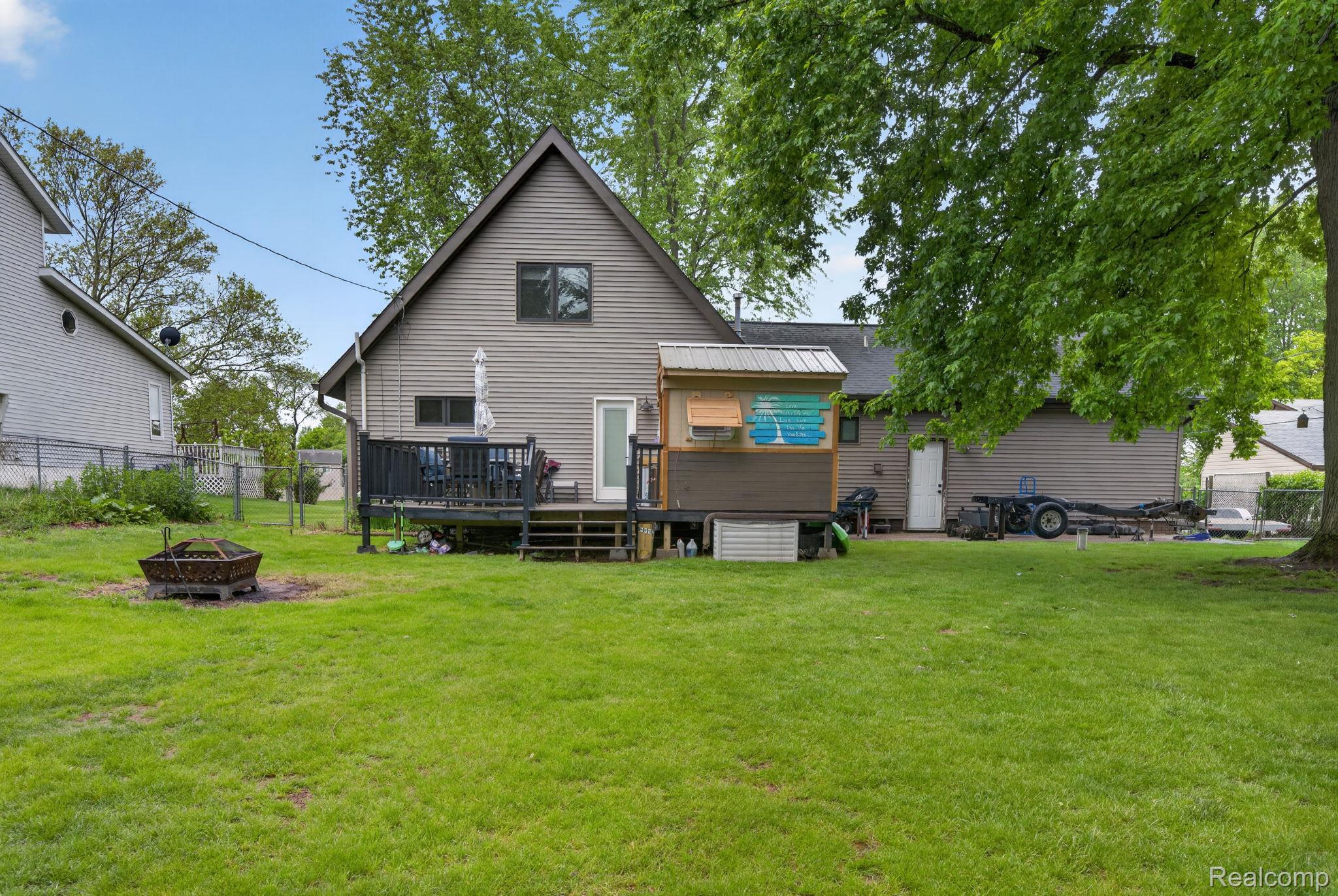 1280 Petts Road Fenton, MI 48430 - Photo 38 of 62 Rear view of property with a fire pit and a deck