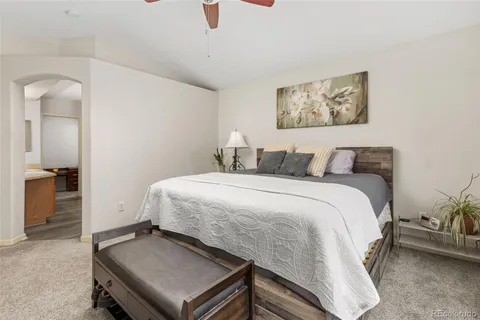 a bedroom with a bed and a table