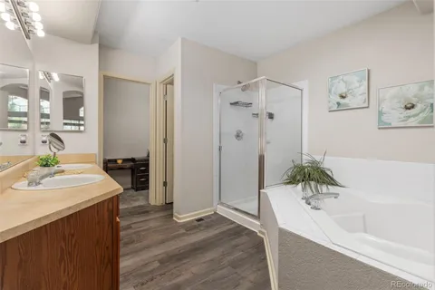 a bathroom with a tub a sink and mirror