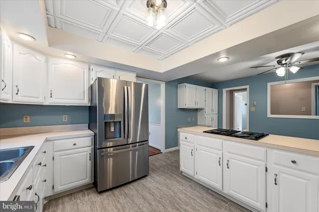 a kitchen with granite countertop a sink stainless steel appliances and cabinets
