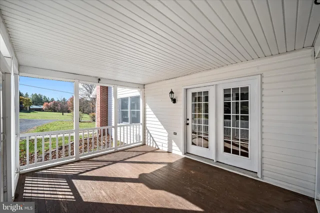 a view of a yard with swimming pool and trees in the background