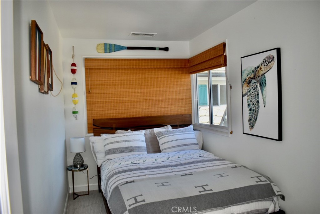 35605 Beach Road Dana Point, CA 92624 - Photo 41 of 61 a bedroom with a bed and a painting on the wall