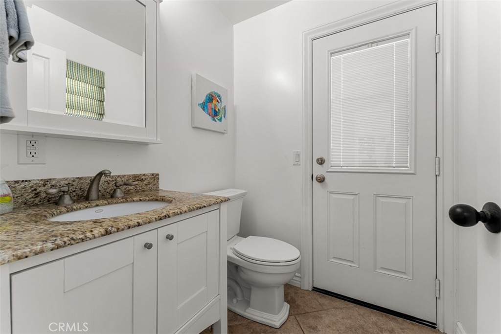 35605 Beach Road Dana Point, CA 92624 - Photo 44 of 61 a bathroom with a granite countertop toilet sink and mirror
