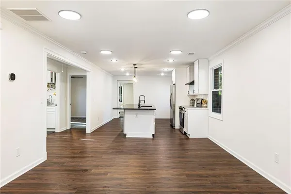 a view of kitchen with kitchen island sink and refrigerator