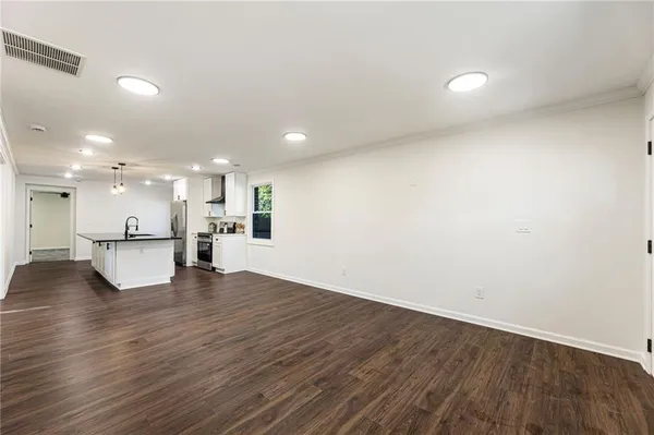a view of kitchen with kitchen island wooden floor and center island