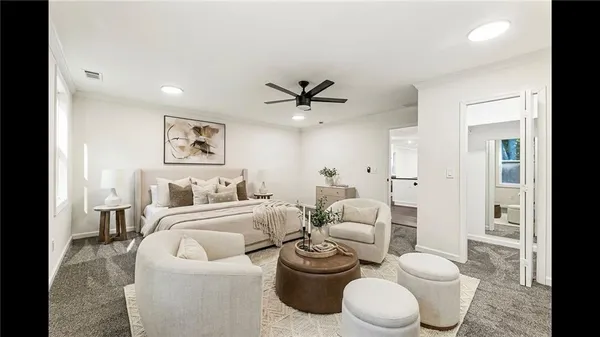 a living room with furniture a window and a ceiling fan