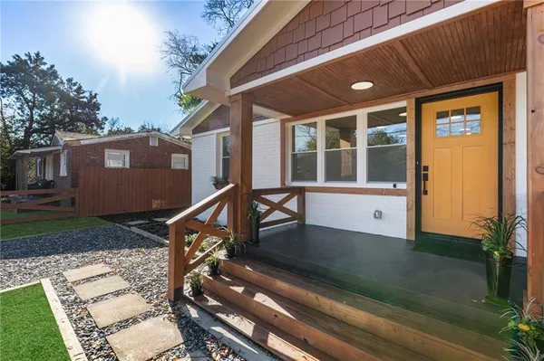 a view of an house with backyard porch and sitting area