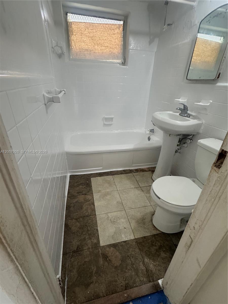 7300 Harding Avenue, Unit 6 Miami Beach, FL 33141 - Photo 4 of 6 a bathroom with a toilet and a sink