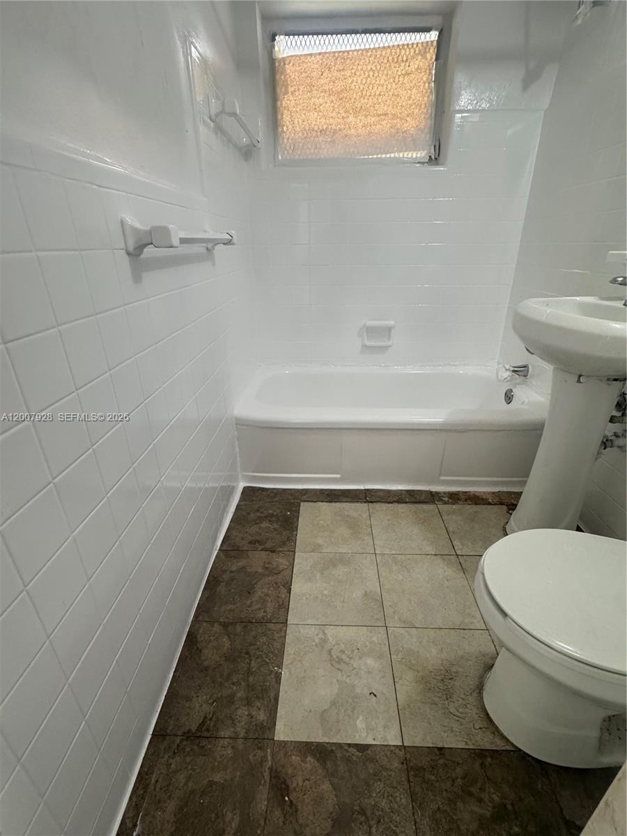 7300 Harding Avenue, Unit 6 Miami Beach, FL 33141 - Photo 6 of 6 a bathroom with a toilet and a shower