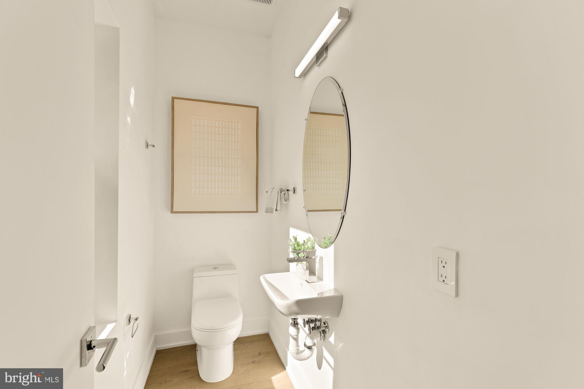 4017 Davis Place Northwest, Unit 8 Washington, DC 20007 - Photo 11 of 28 a bathroom with a sink a toilet and mirror