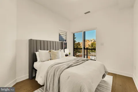 a bedroom with a large bed and a window