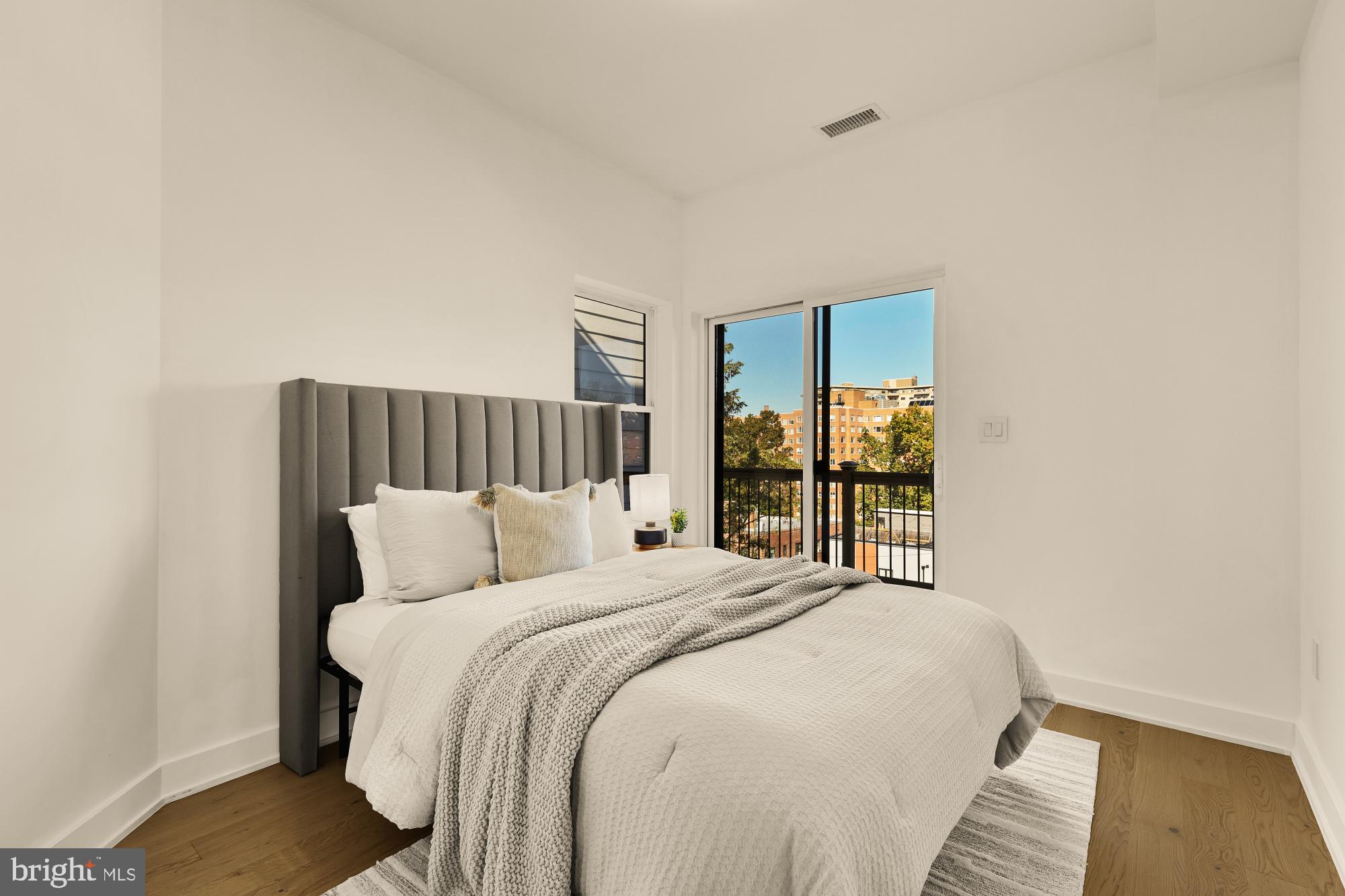 4017 Davis Place Northwest, Unit 8 Washington, DC 20007 - Photo 12 of 28 a bedroom with a large bed and a window