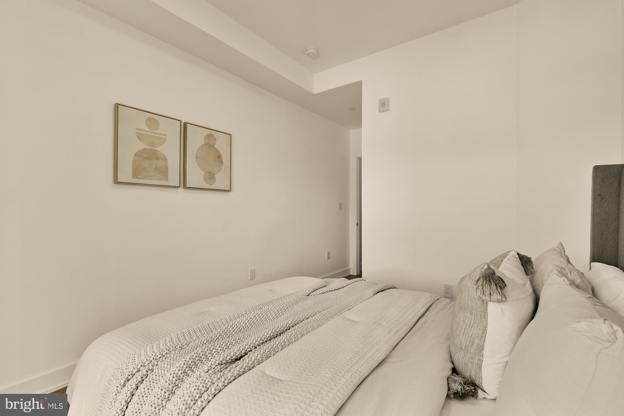 4017 Davis Place Northwest, Unit 8 Washington, DC 20007 - Photo 13 of 28 a bedroom with a bed and a flat screen tv