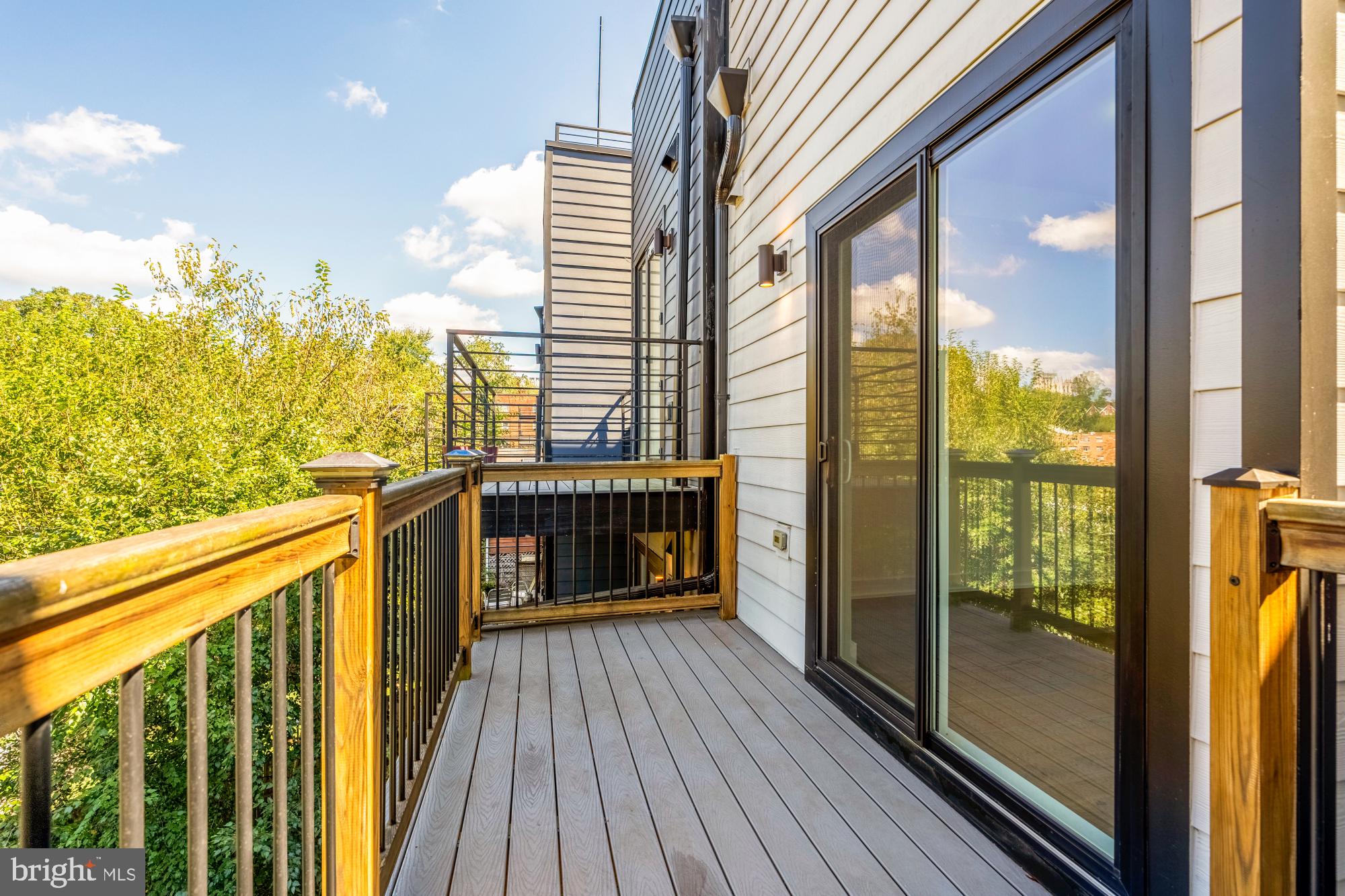 4017 Davis Place Northwest, Unit 8 Washington, DC 20007 - Photo 14 of 28 a view of a balcony with floor to ceiling window wooden floor and outdoor seating
