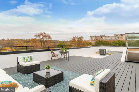 a view of a terrace with couches and sky view