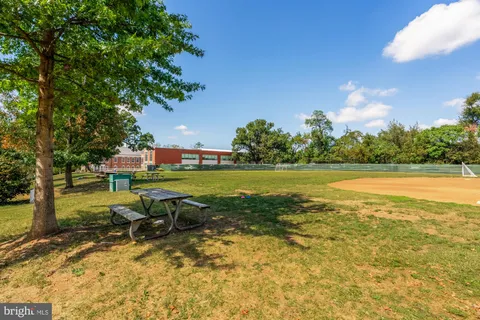 a view of a swimming pool and lounge chairs