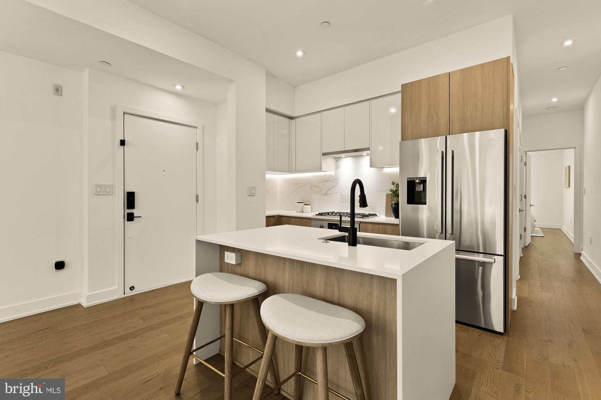 4017 Davis Place Northwest, Unit 8 Washington, DC 20007 - Photo 5 of 28 a kitchen with stainless steel appliances a sink and a refrigerator