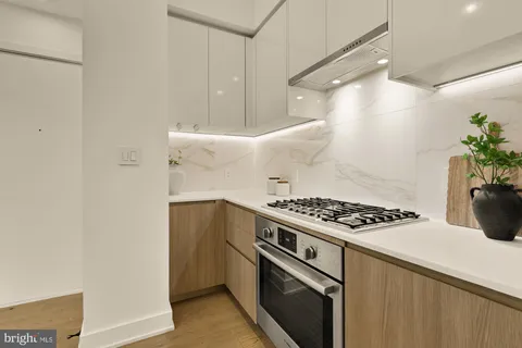 a kitchen with granite countertop a stove and a refrigerator