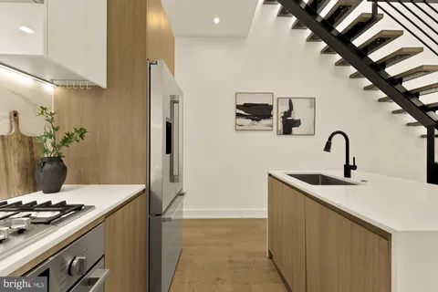 a kitchen with a sink and a stove top oven