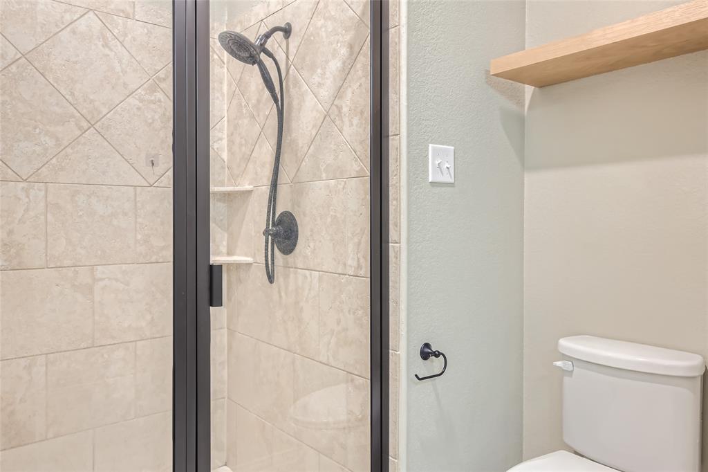 204 West Patton Street Alvarado, TX 76009 - Photo 10 of 17 a bathroom with a shower and toilet