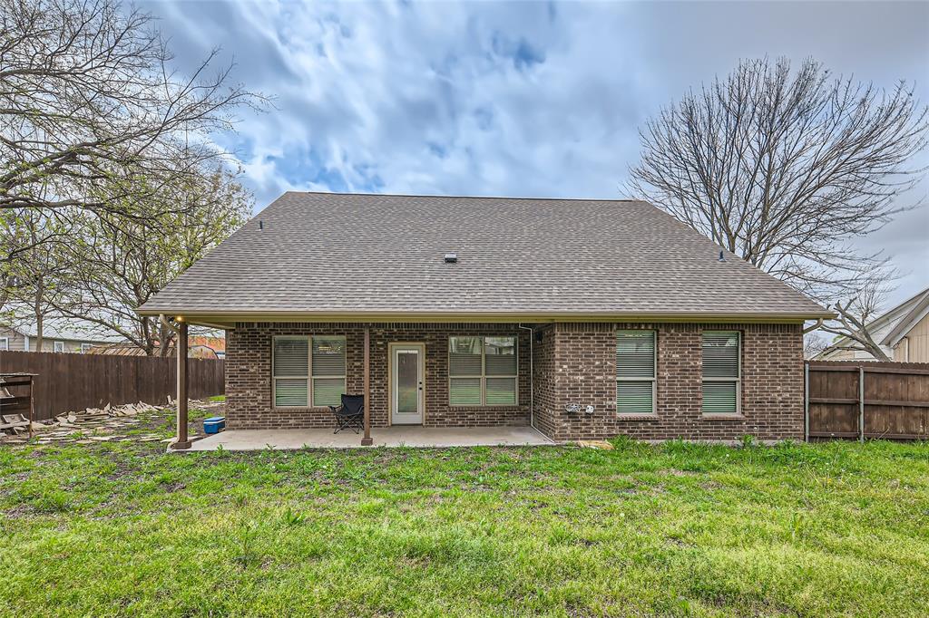 204 West Patton Street Alvarado, TX 76009 - Photo 15 of 17 a front view of a house with a garden
