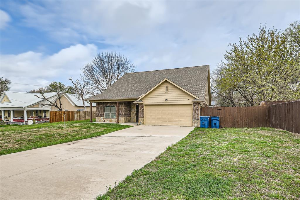 204 West Patton Street Alvarado, TX 76009 - Photo 2 of 17 a front view of a house with a yard and garage