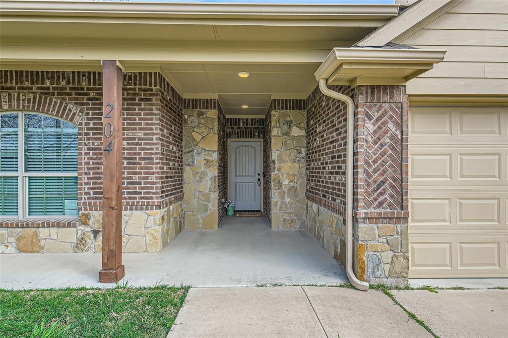 204 West Patton Street Alvarado, TX 76009 - Photo 3 of 17 a front view of a house with a garage